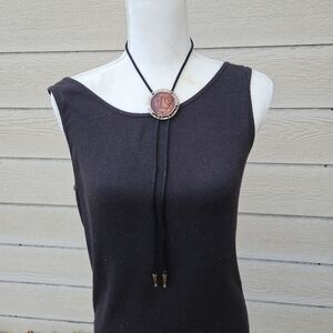 gold tone and brown leather abstract face bolo tie on black cord